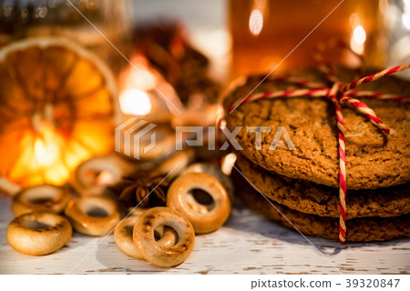 Cozy still life of tea, christmas light and pastry Cozy still life of tea, christmas light and pastry 39320847