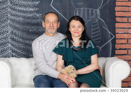 Senior Grey-haired Man Sitting on the White Sofa 39323029