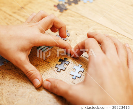 little kid playing with puzzles on wooden floor little kid playing with puzzles on wooden floor 39323415