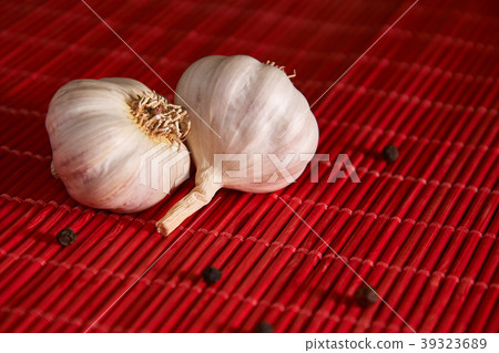 garlic, black pepper on a red style background garlic, black pepper on a red style background 39323689