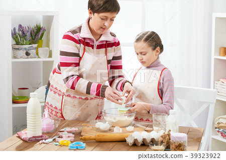 Mother and daughter cook at home. make dough Mother and daughter cook at home. make dough 39323922