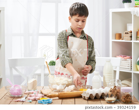 Boy cooking at home, making dough, buns and cookie 39324159