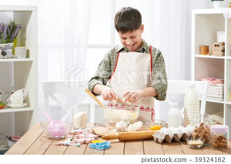 Boy cooking at home, making dough, buns and cookie 39324162