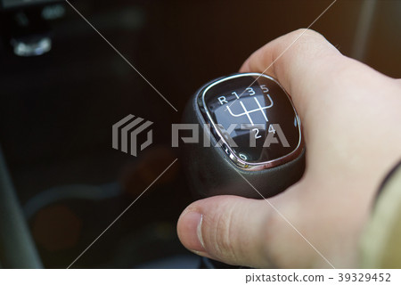 Close up of manual gear stick in hand Close up of manual gear stick in hand 39329452