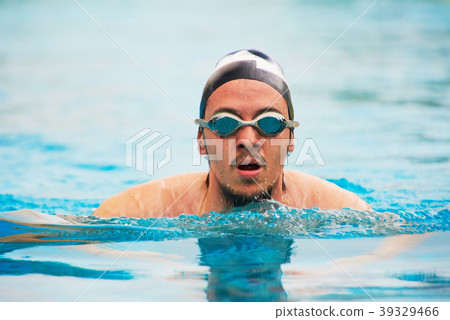 Man in goggles swimming in pool Man in goggles swimming in pool 39329466