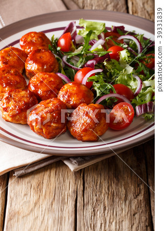Tasty glazed meatballs with fresh vegetable salad 39331839