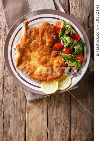 veal Milanese with lemon and fresh salad veal Milanese with lemon and fresh salad 39332143