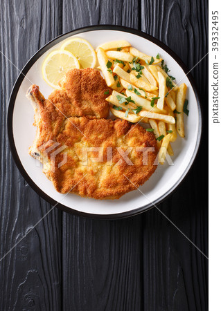 Italian veal Milanese with lemon and French fries 39332495