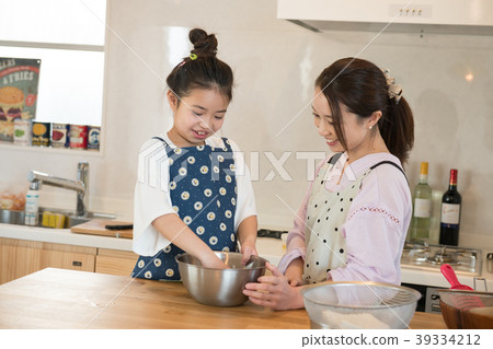Elementary school girl helping in the kitchen Elementary school girl helping in the kitchen 39334212