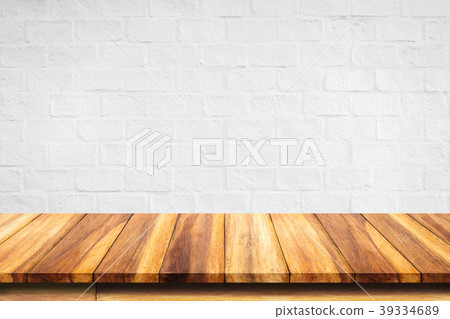 wooden table on white brick wall background. 39334689