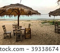 Side of chairs set with umbrella on the beach back 39338674