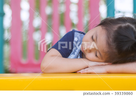 Cute a Little Asian Girl sleeping in the Playground. Cute a Little Asian Girl sleeping in the Playground. 39339860