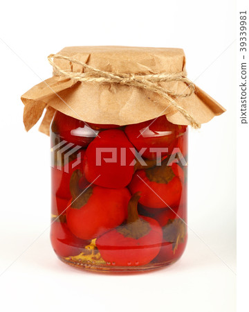 Jar of pickled red hot chili peppers over white 39339981