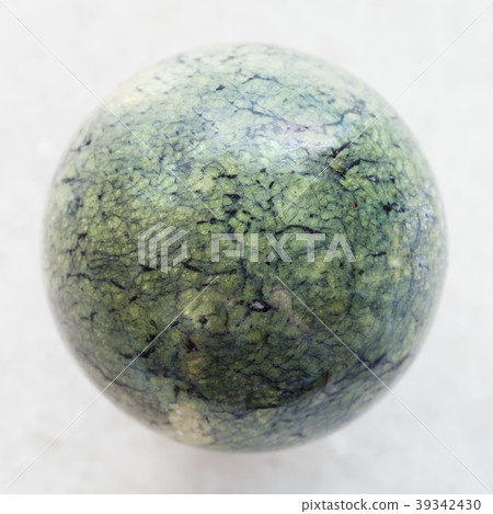 bead from Serpentine gemstone on white marble 39342430