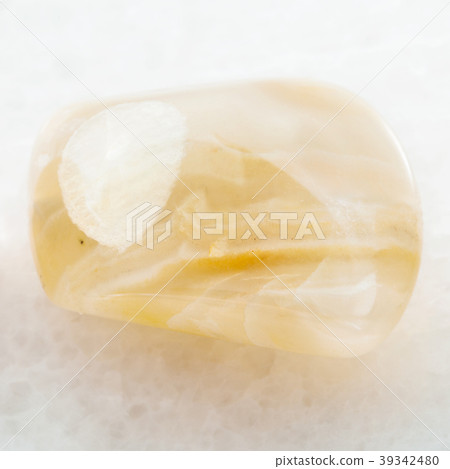 polished yellow banded Agate gemstone on white 39342480
