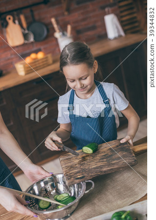 Mother and daughter cooking Mother and daughter cooking 39344832