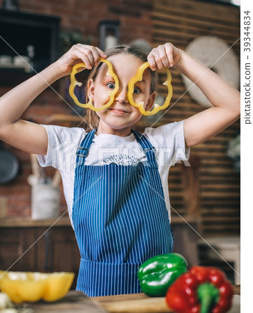 Young girl is playing in the kitchen Young girl is playing in the kitchen 39344834