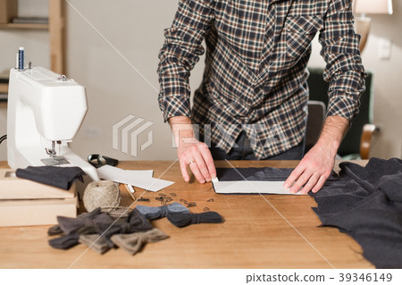 Cutting dark wool fabric. the line pattern. Young Cutting dark wool fabric. the line pattern. Young 39346149