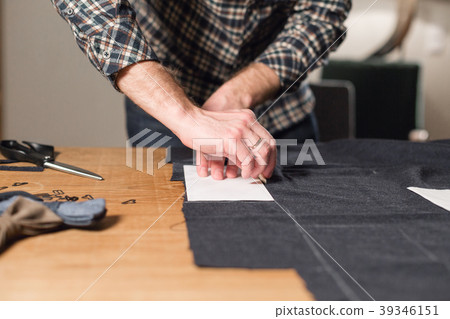 Cutting dark wool fabric. the line pattern. Young Cutting dark wool fabric. the line pattern. Young 39346151