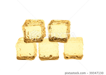 Golden ice cubes on white background. 39347130