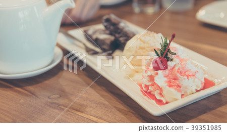 chocolate cake served and ice cream on table. 39351985