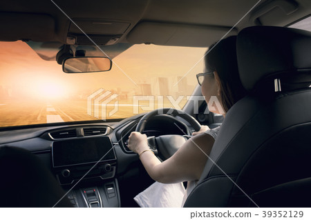 woman driving car on urban highway woman driving car on urban highway 39352129