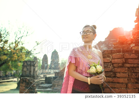 thai woman standing with pink lotus flower thai woman standing with pink lotus flower 39352135