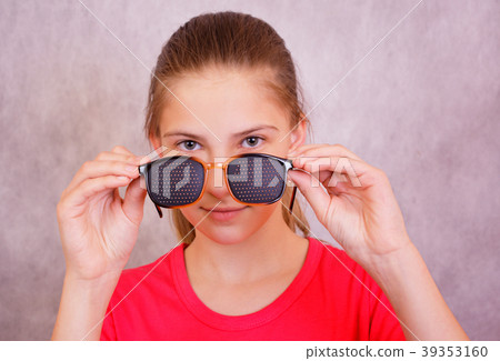 Girl holding in the hands of the training glasses Girl holding in the hands of the training glasses 39353160