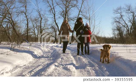 Little girl playing with her dog on snow 39355595