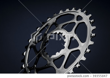 Black oval bicycle chainring, black background 39355847