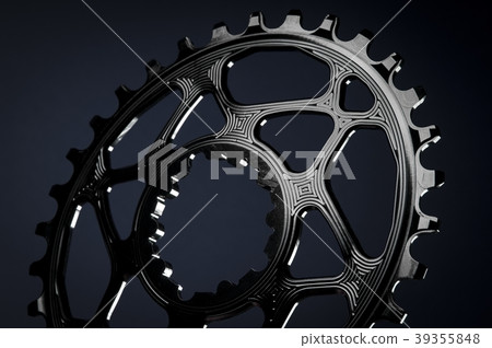 Black oval bicycle chainring, black background Black oval bicycle chainring, black background 39355848
