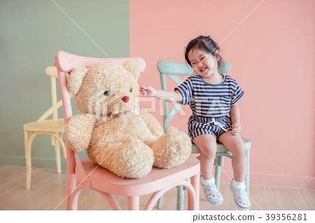 A Two Years Old Child Sitting with her Teddy Bear. A Two Years Old Child Sitting with her Teddy Bear. 39356281