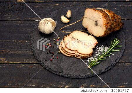 Cutting meat on a black stone tray. 39361757