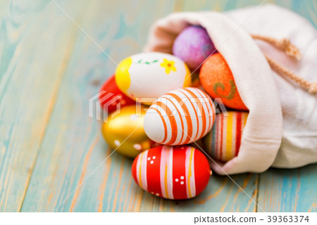 Several colorful Easter eggs in sack close Several colorful Easter eggs in sack close 39363374