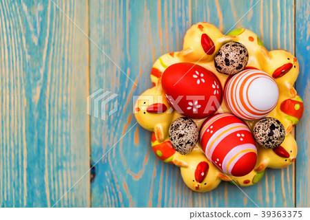 Several colorful Easter eggs in decorative tray 39363375