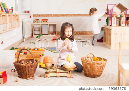 cute little girl is playing with scales cute little girl is playing with scales 39363878