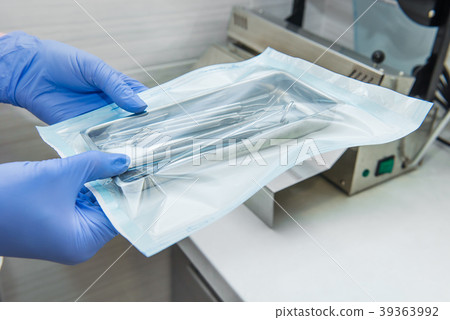 Close up dentist assistant's hands holding 39363992