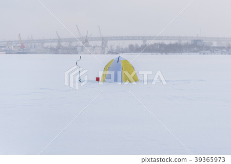 Ice fishing equipment: tent, drill, bucket on ice 39365973