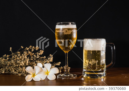 beer on wood table and black background 39370080