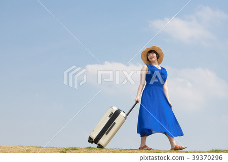 Young woman pulling a carry bag 39370296