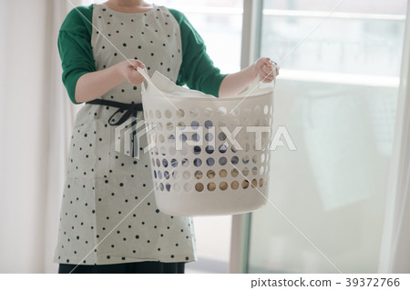 A young lady with a laundry basket 39372766