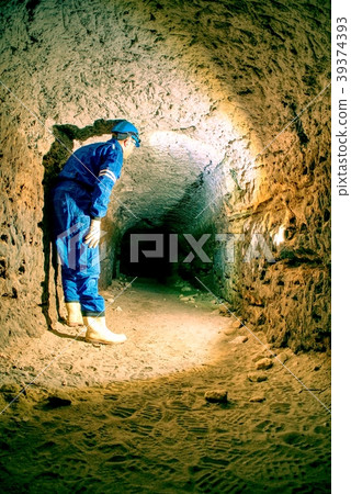 Workerman with helmet and protective suit, tunnel Workerman with helmet and protective suit, tunnel 39374393