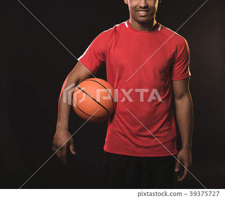 Man in red t-shirt with orange ball 39375727