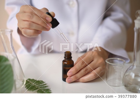scientist hand pour,drop oil or serum laboratory scientist hand pour,drop oil or serum laboratory 39377880