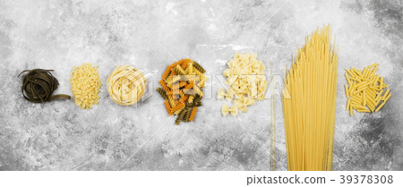 Various raw pasta on gray background. Top view Various raw pasta on gray background. Top view 39378308