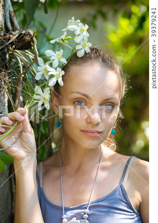 girl with a branch of a white orchid girl with a branch of a white orchid 39379241