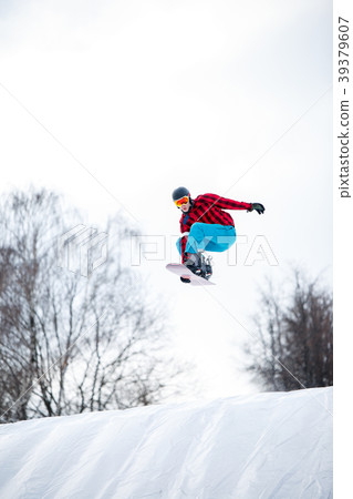 Picture of athlete in helmet riding snowboard from 39379607
