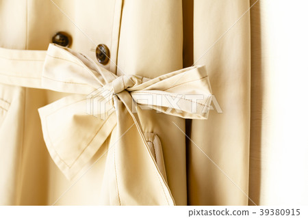A ribbon tie on a trench coat waist strap A ribbon tie on a trench coat waist strap 39380915