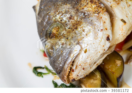 Head of baked dorado fish. 39381172