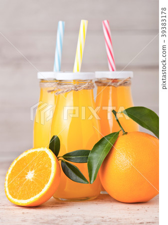 Glass bottles of raw organic fresh orange juice Glass bottles of raw organic fresh orange juice 39383178